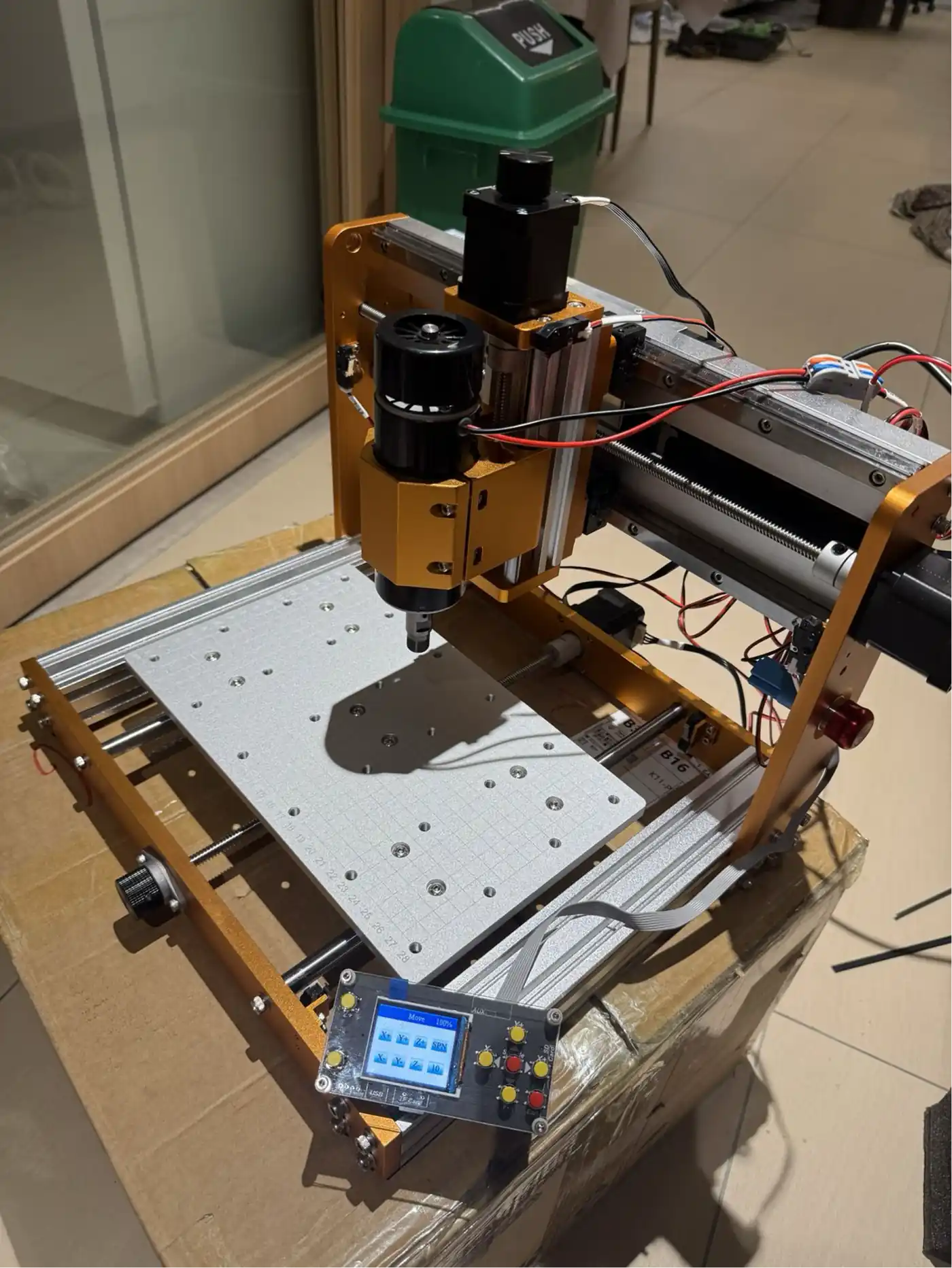 Desktop CNC running with the LCD coordinate display active – the machine is calibrated and ready for its first job