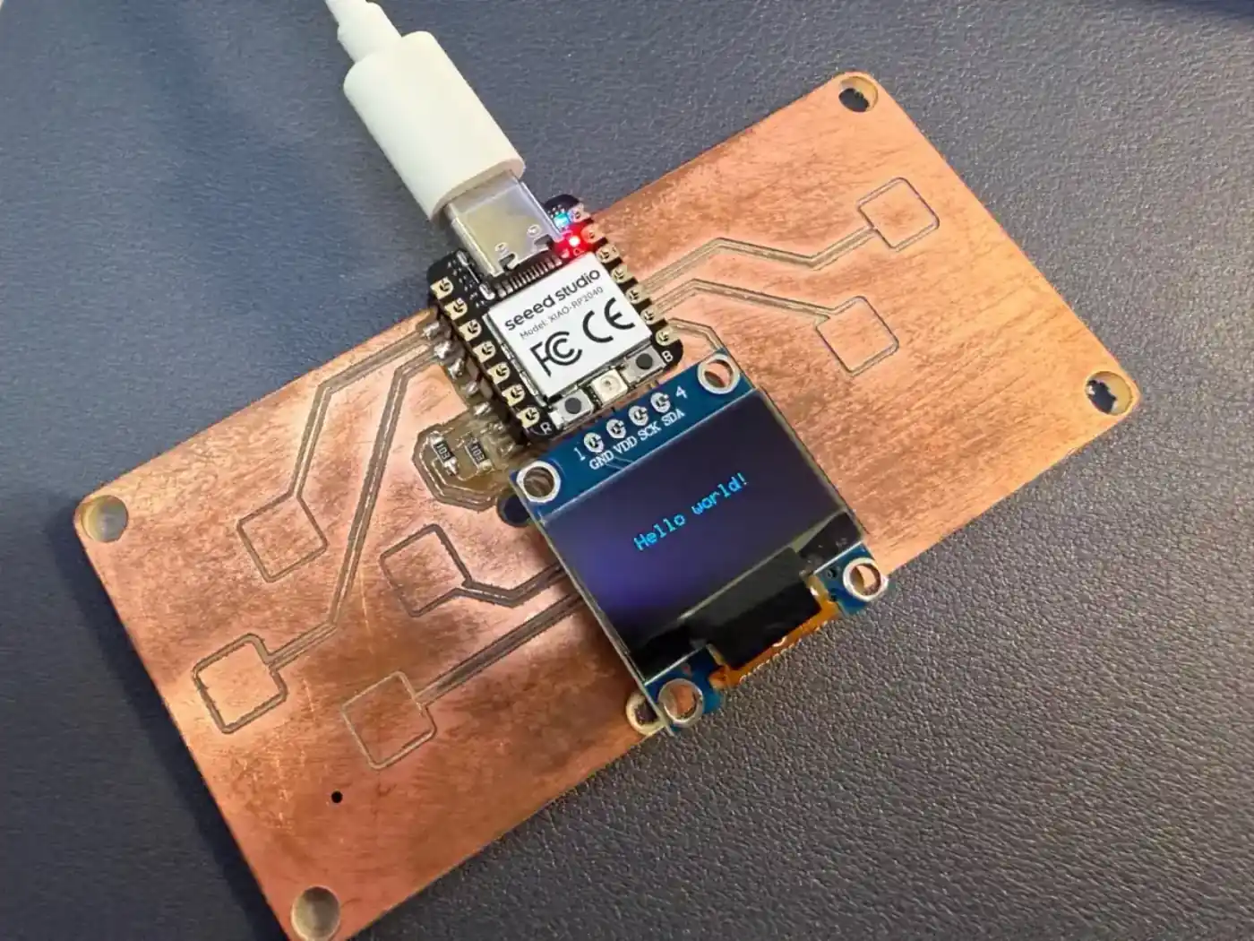 QPad with XIAO RP2040, OLED display, and components connected for testing