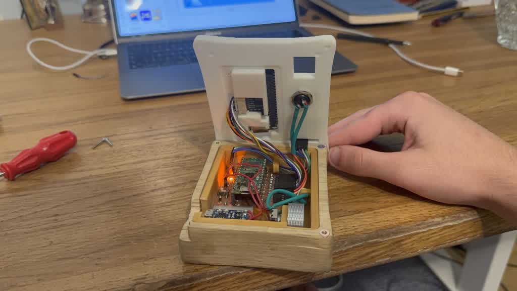 Opened build — cable guides on the enclosure wall, e-ink flex kept clear