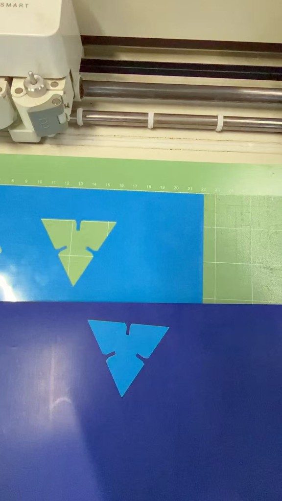 Blue vinyl triangles cut on the mat
