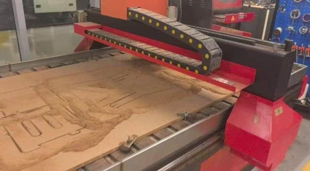 CNC cutting chair parts with dust on the sheet
