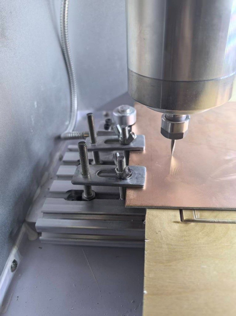 Copper clad board clamped on the PCB CNC