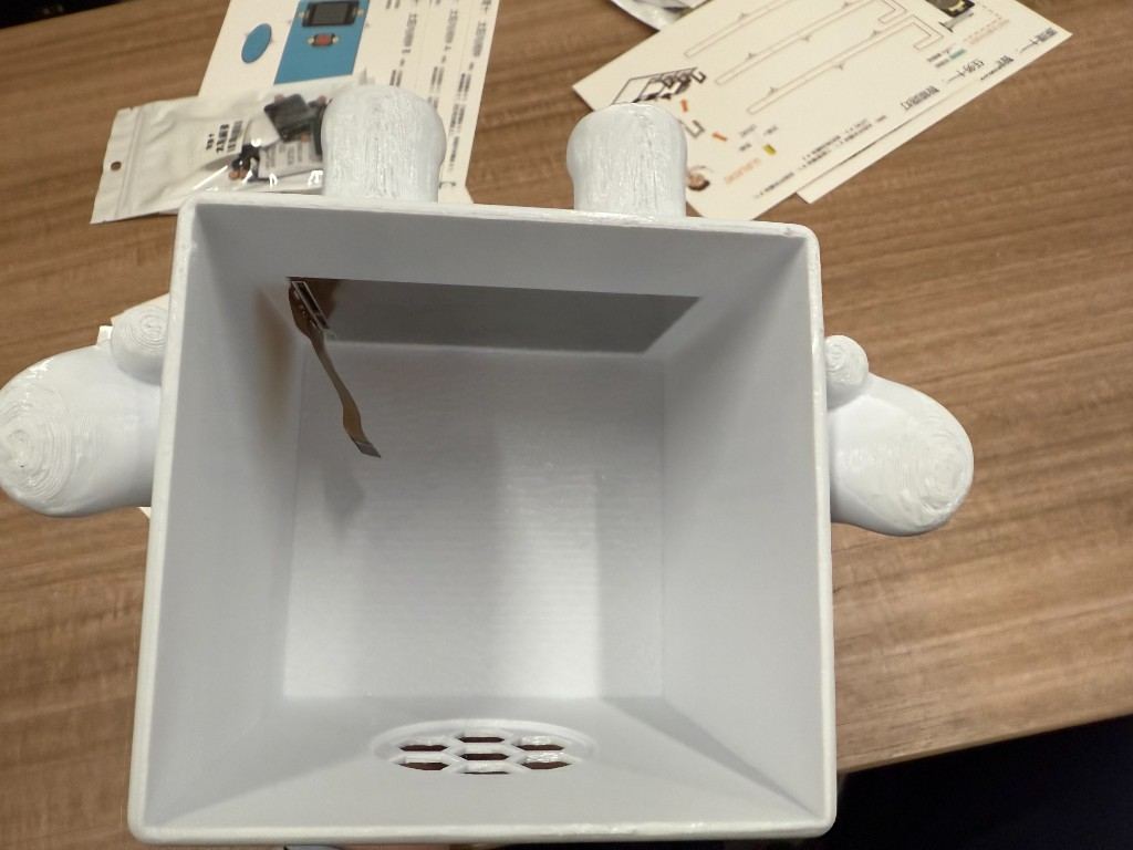 Top-down interior view of version 2 with display and ribbon cable inside