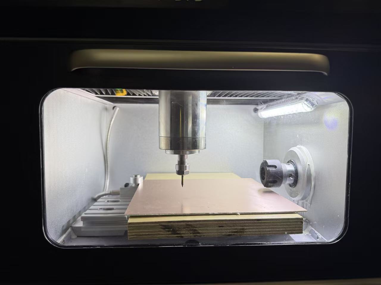 Placing and securing the copper-clad board on the PCB mill