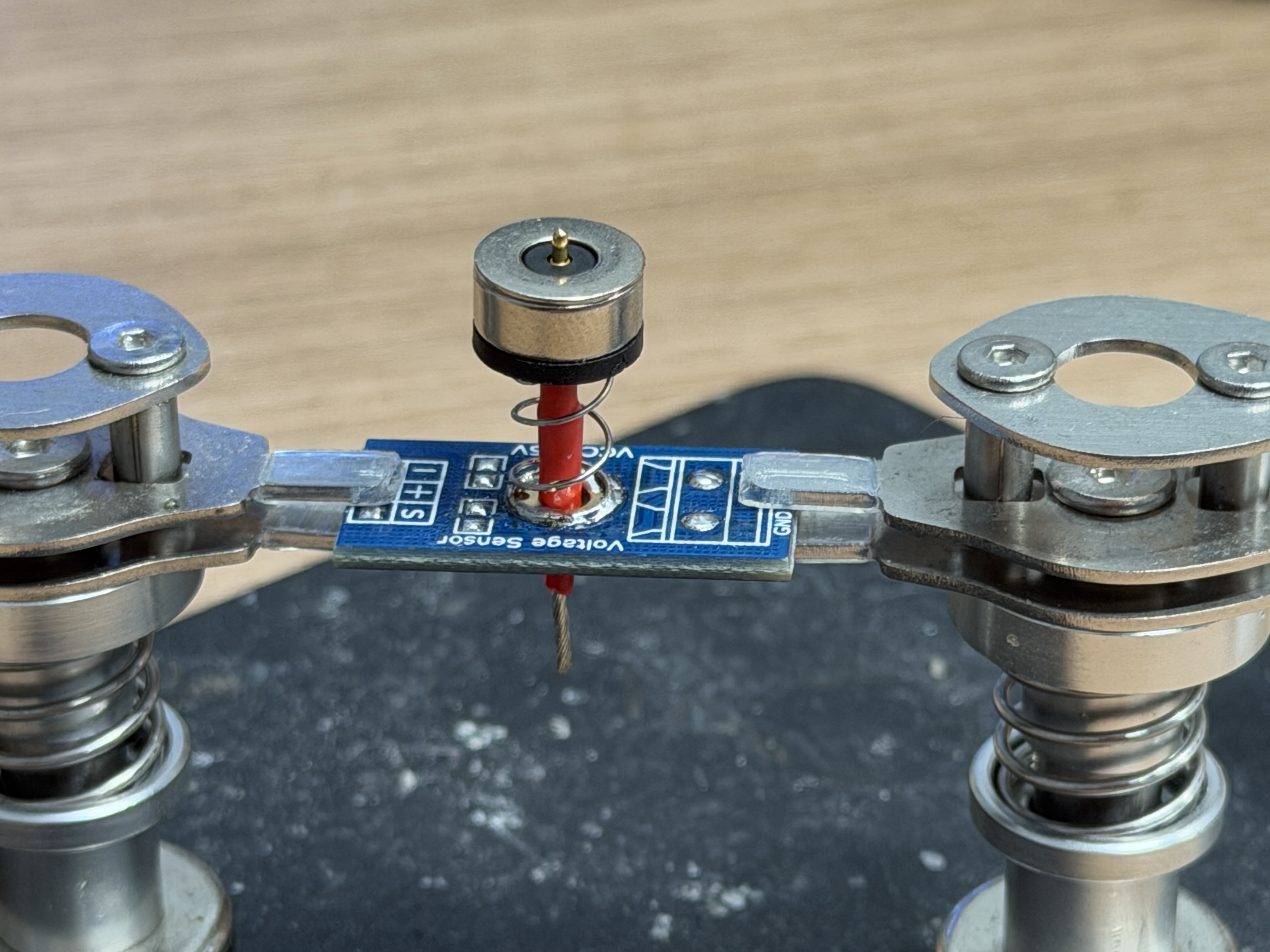 Magnetic pogo charging contacts being soldered on the dock face