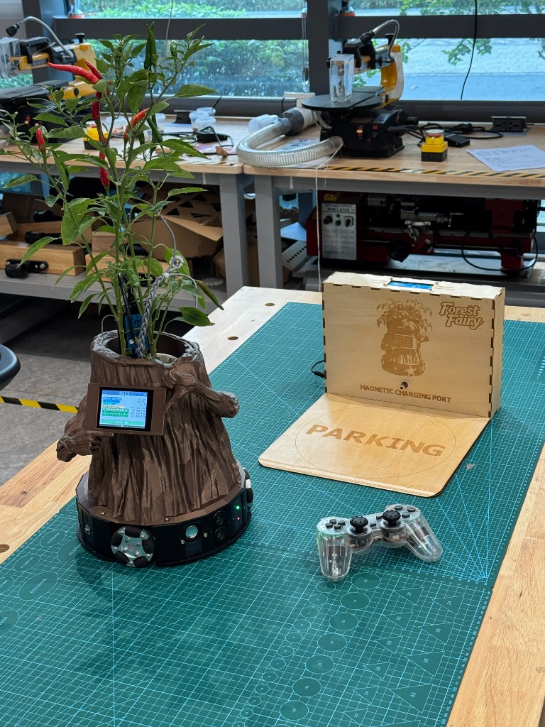Finished Forest Fairy prototype with chili plant, display, charging dock, and controller