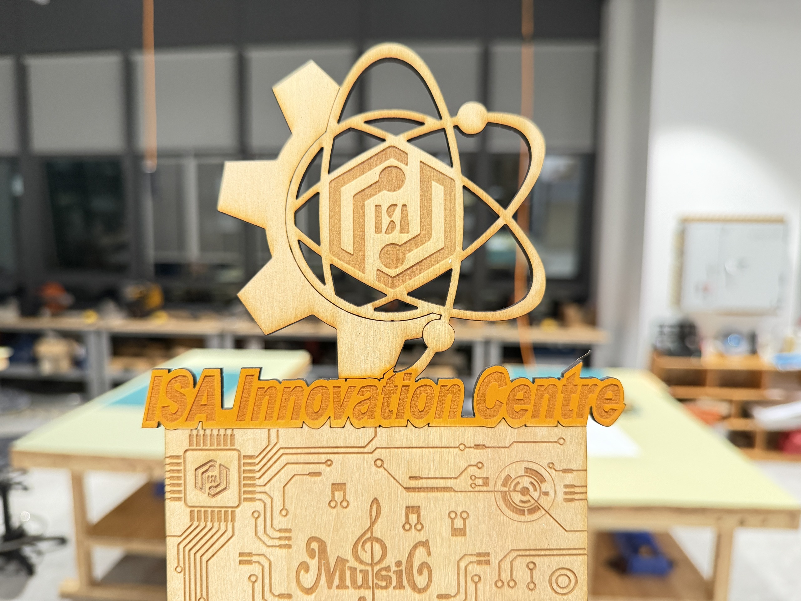 Spraying orange paint while using first laser-cut mask on bracket