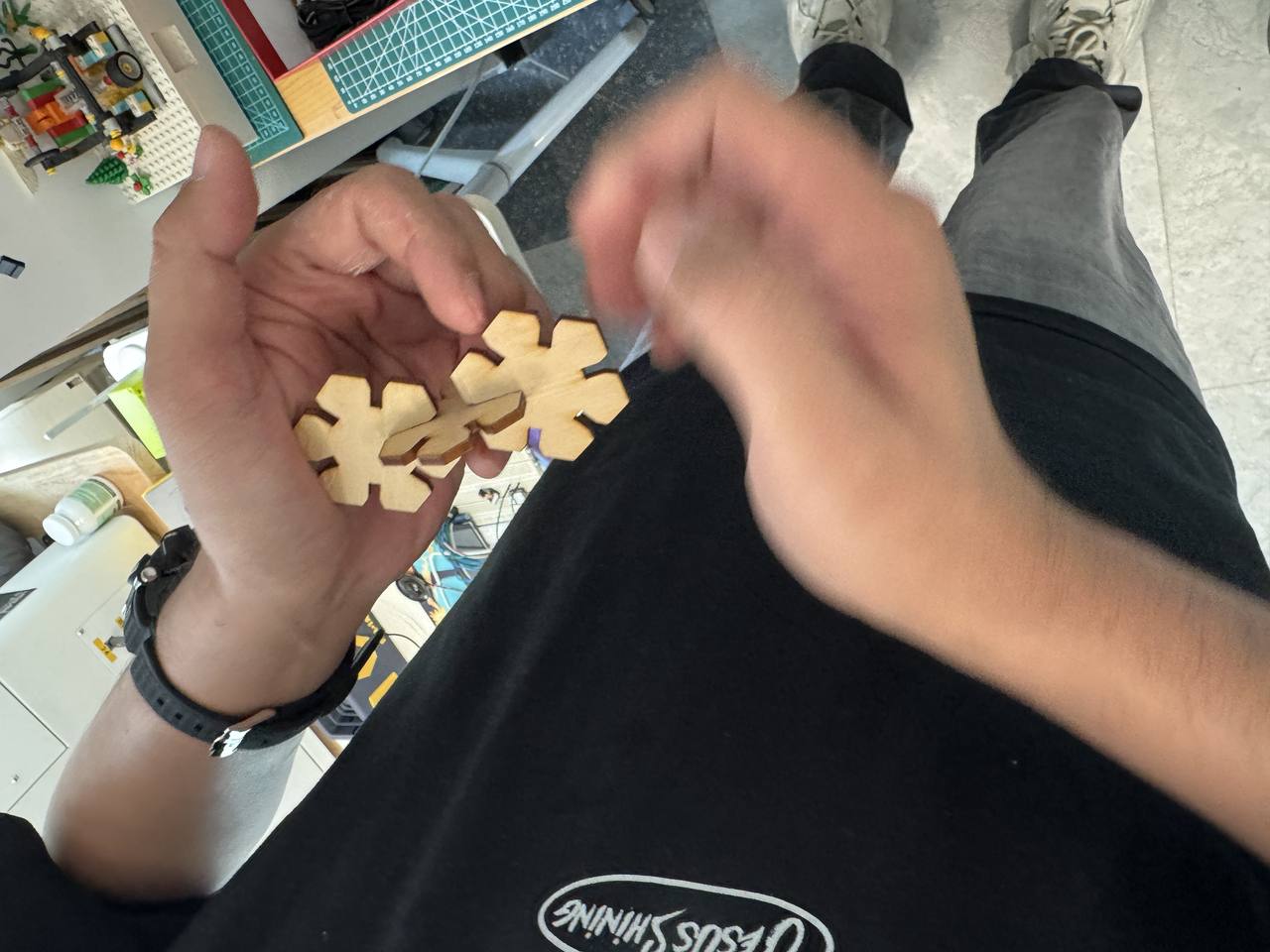 Laser-cut snowflake pieces assembled flat into a star pattern