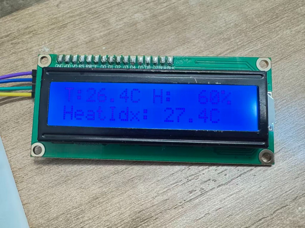 LCD1602 close-up showing temperature, humidity, and heat index readings from the physical DHT11 circuit