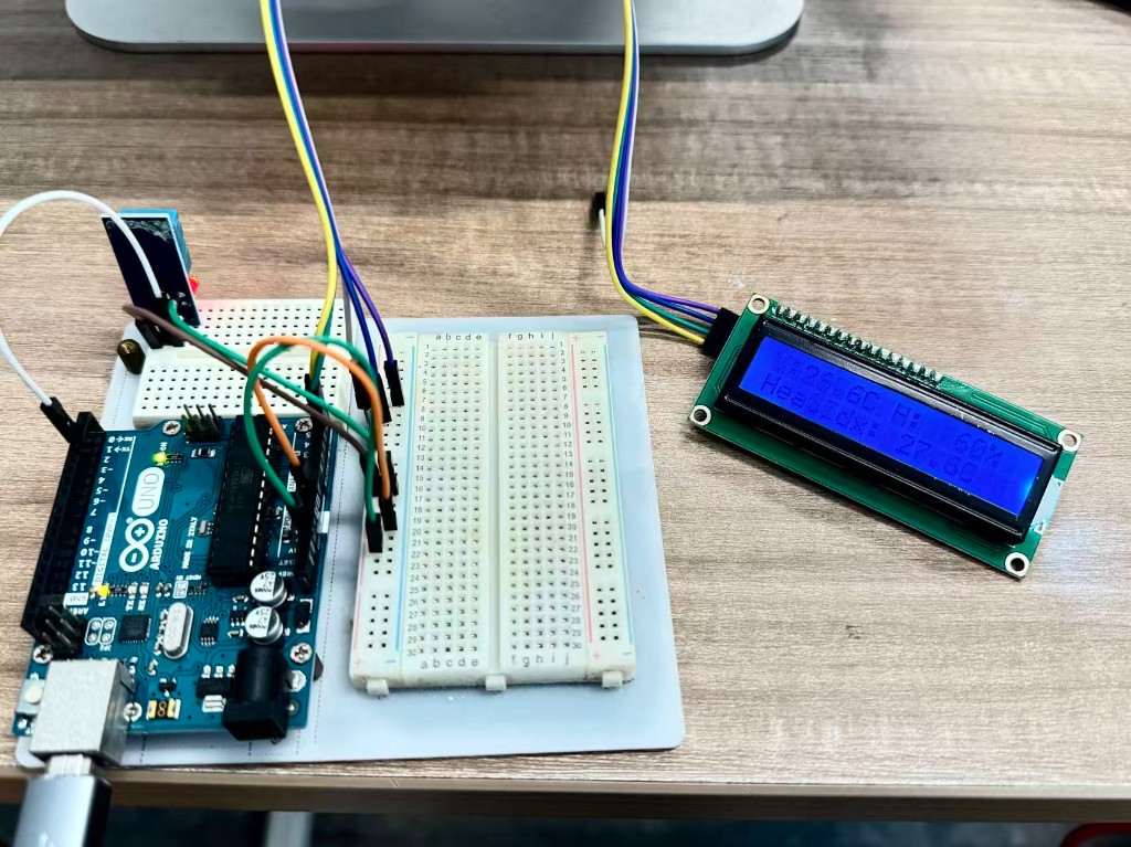 Physical Arduino Uno circuit with DHT11 sensor on a breadboard and LCD1602 I2C display