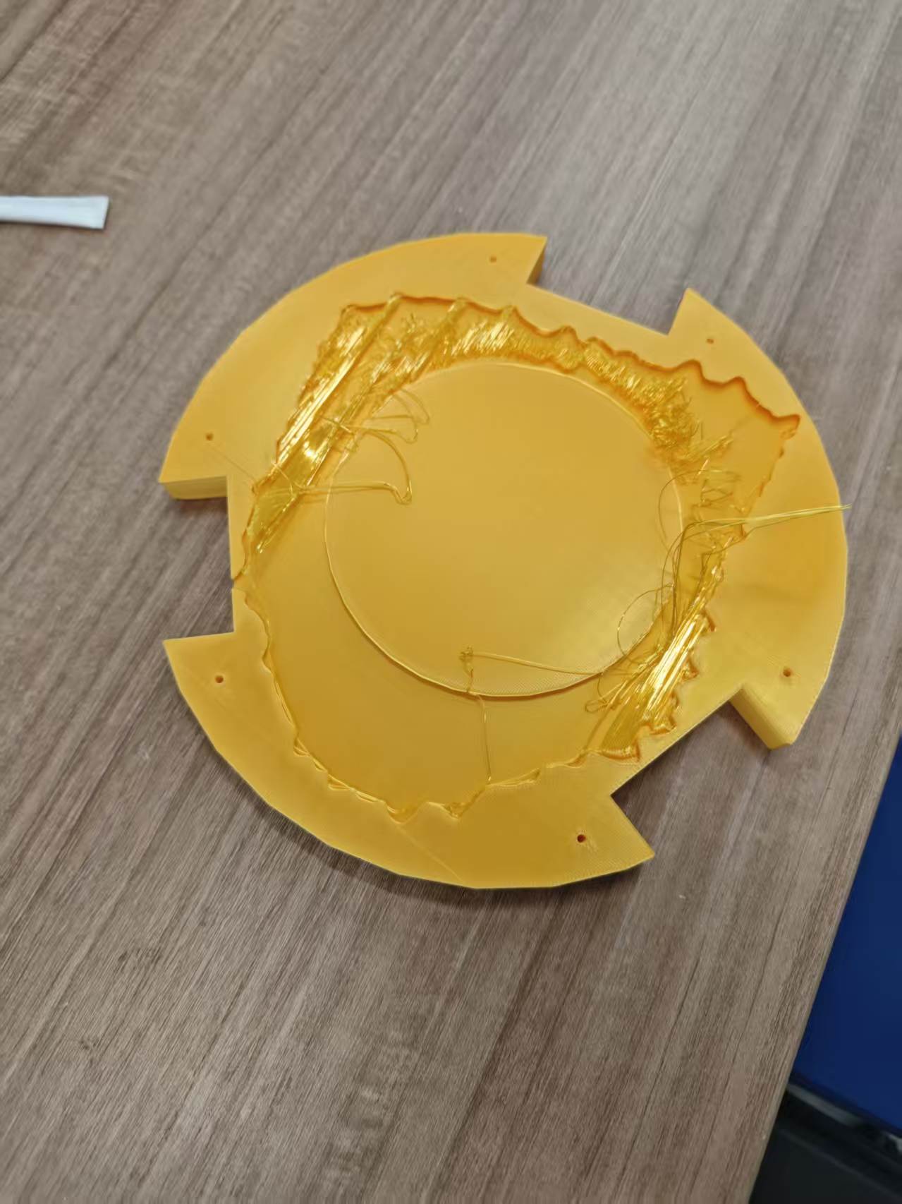 Discarded first 3D print showing stringing and poor top surfaces where the root and base should meet