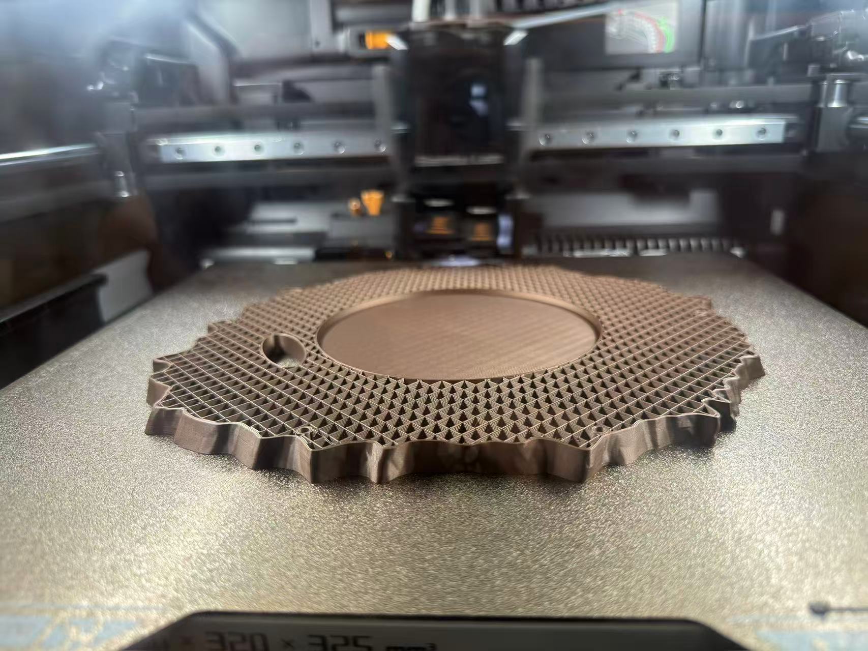 Bambu Lab H2D build plate: planter and wheel-base print early in the job, first layers and outline visible