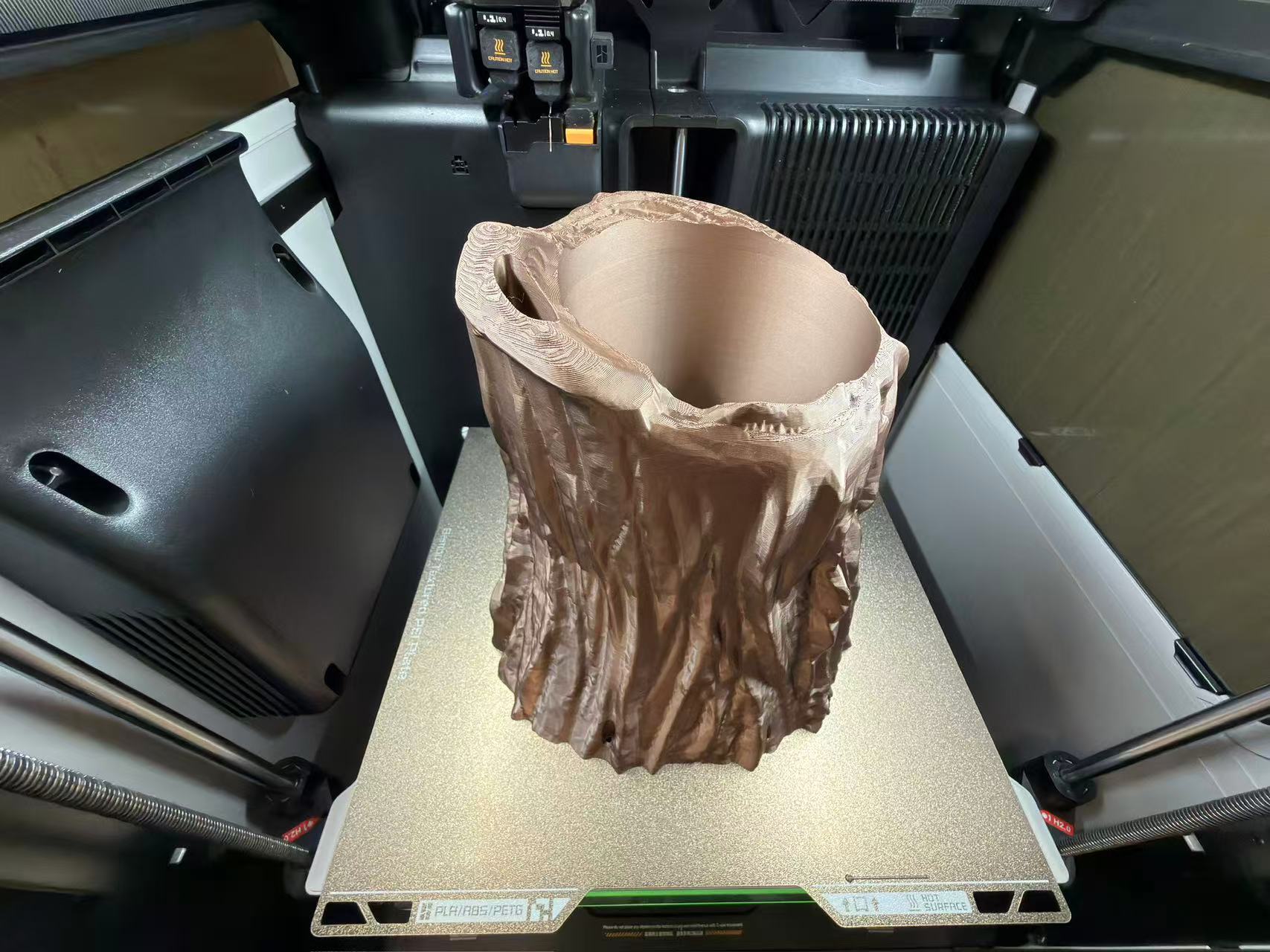 FDM print in progress: root planter geometry rising above the wheel plate