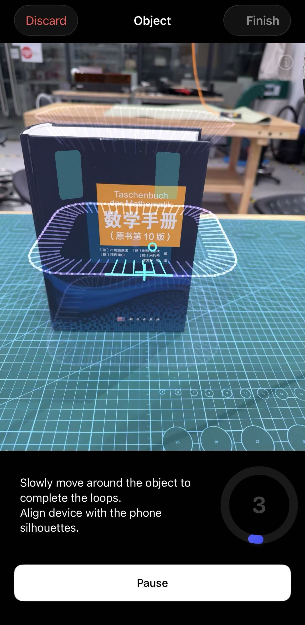 Luma 3D scanning interface showing orbit guide loops around a standing book