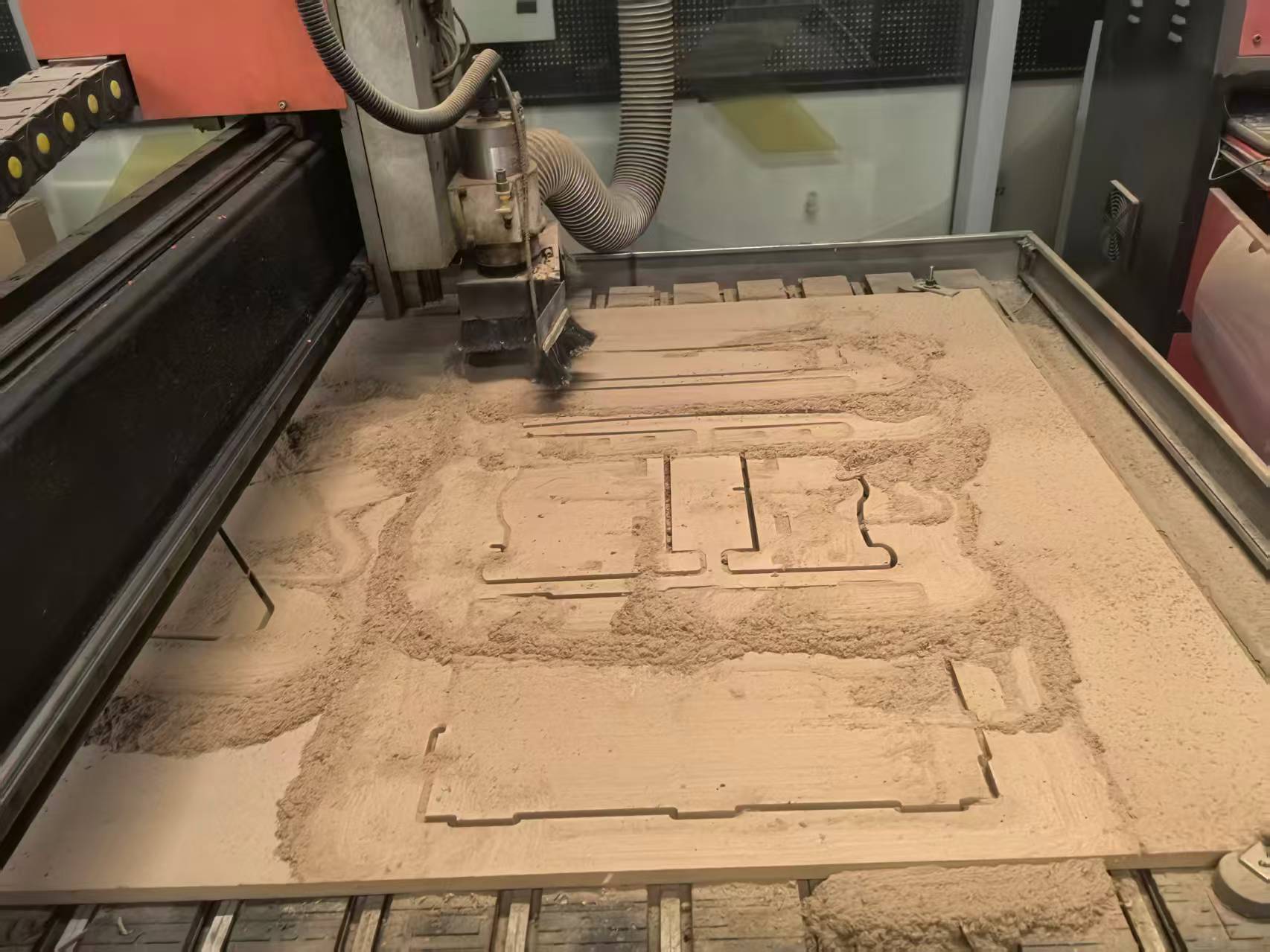 CNC bed after cutting — dog bed parts still tabbed in the sheet