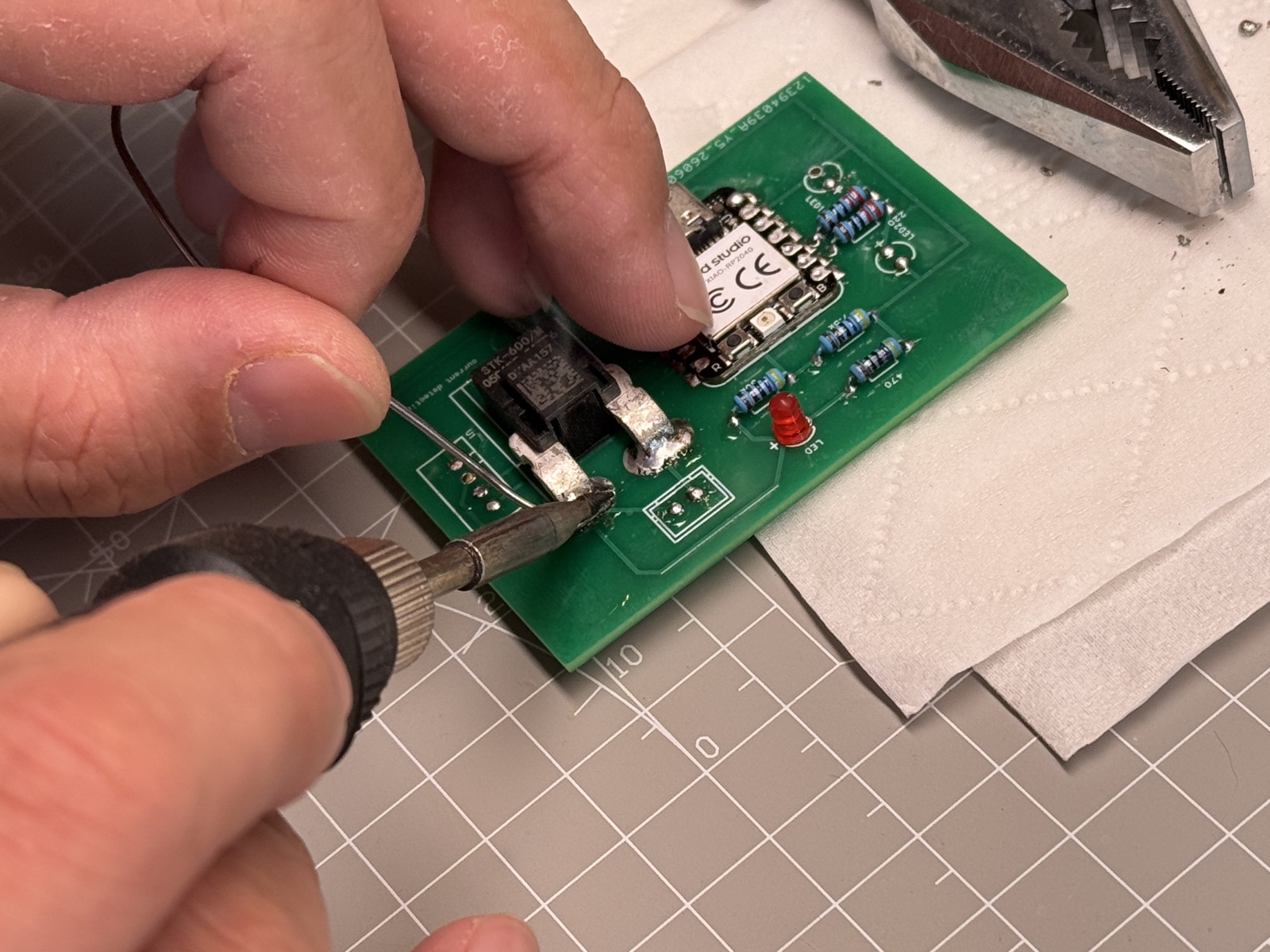 Soldering the STK-600/M current detection module onto the charging dock PCB