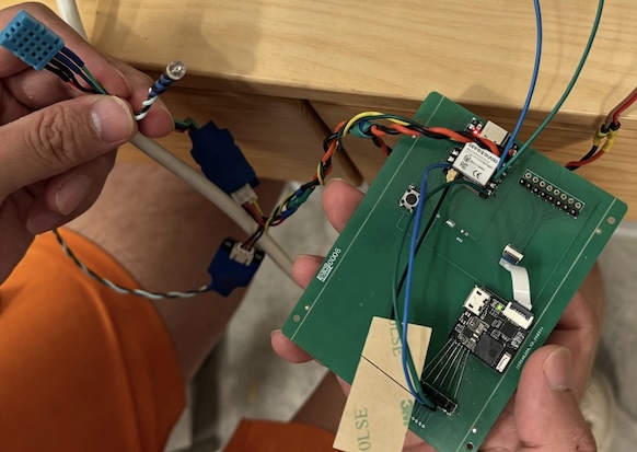 Connected build: XIAO PCB hub wired to breadboard display with SDA, SCL, and power