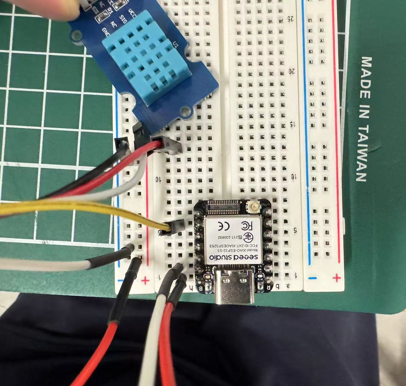 Seeed XIAO ESP32-S3 on a breadboard with a DHT11 module and jumper wires