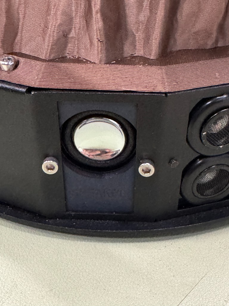 Front speaker installed in the mobile base next to the ultrasonic sensor openings