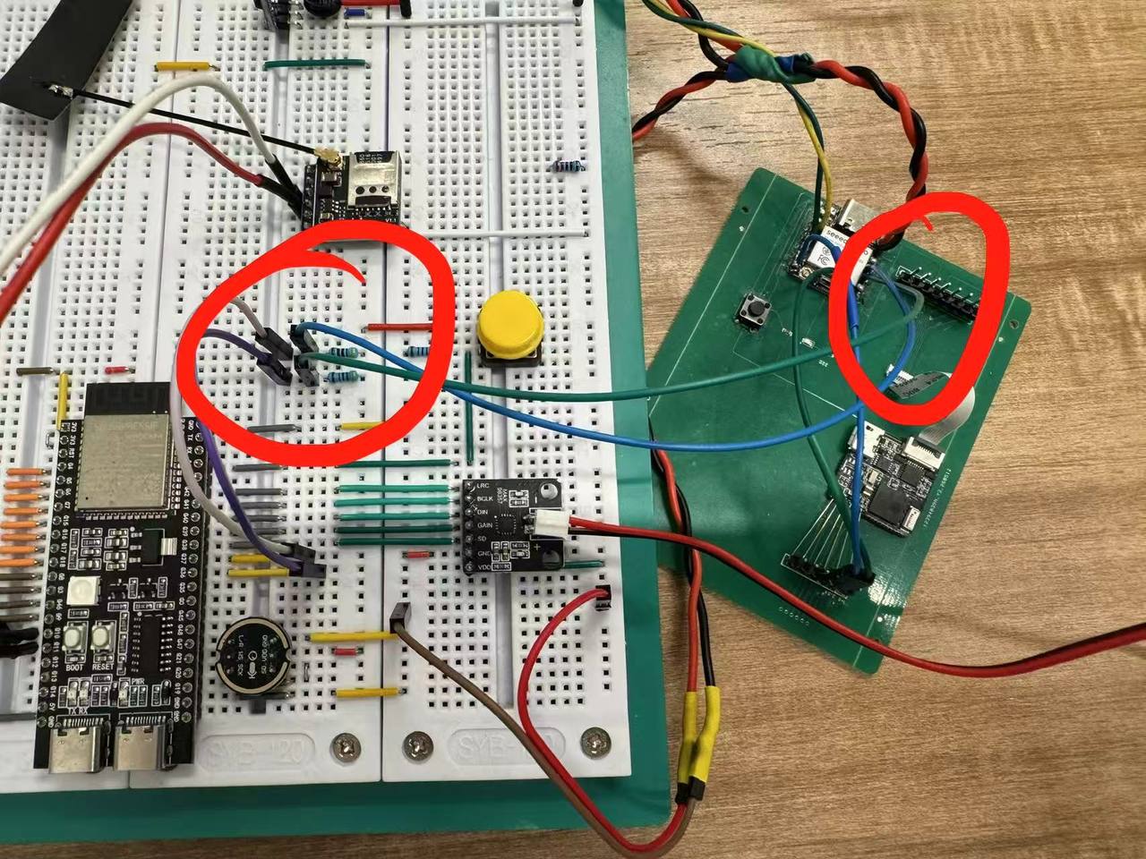 Breadboard with ESP32-S3 WROOM display board and Seeed XIAO ESP32-S3 linked by I2C wires highlighted in red circles
