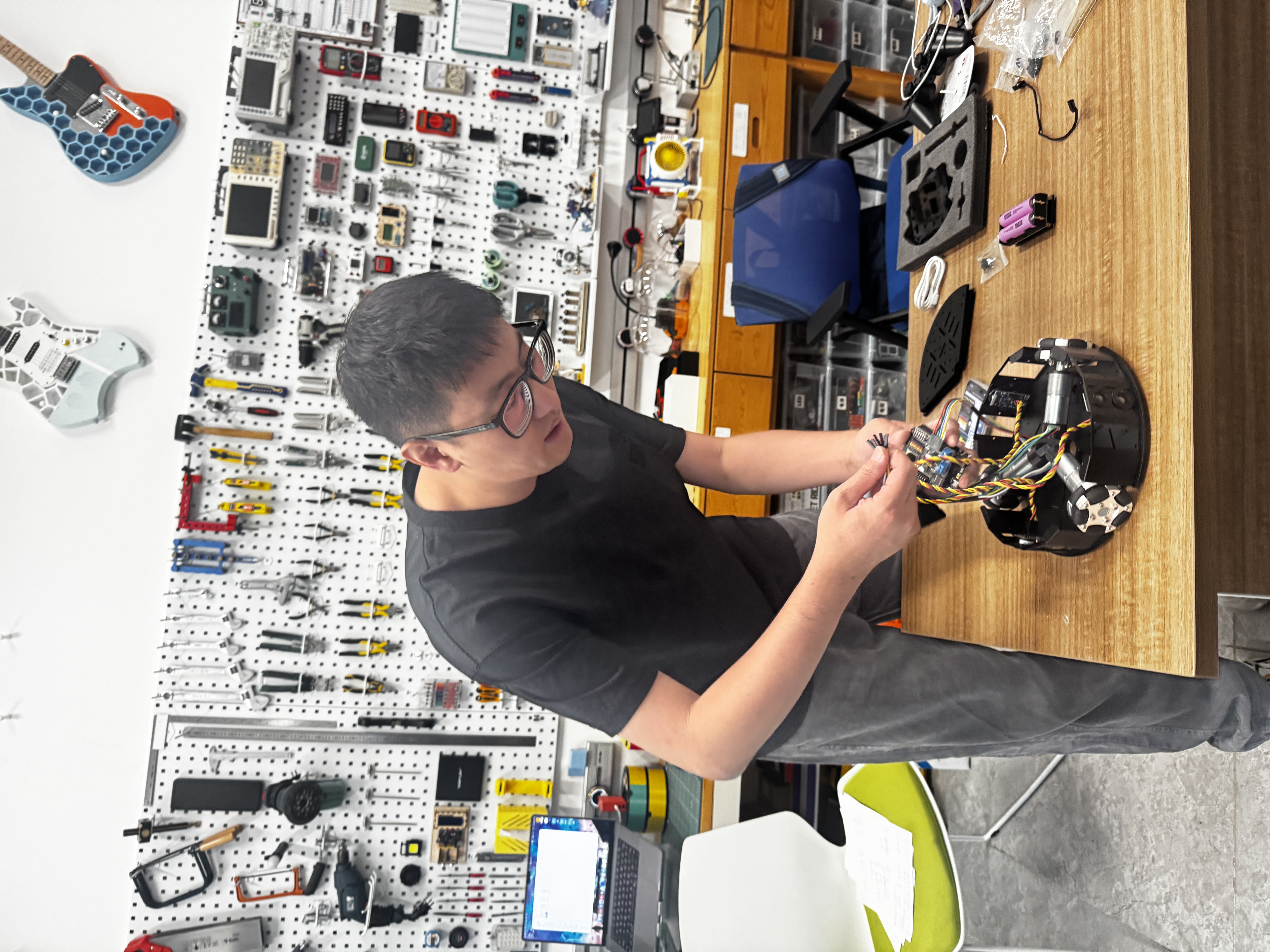 Three geared omni-wheel motors installed and wired on circular chassis