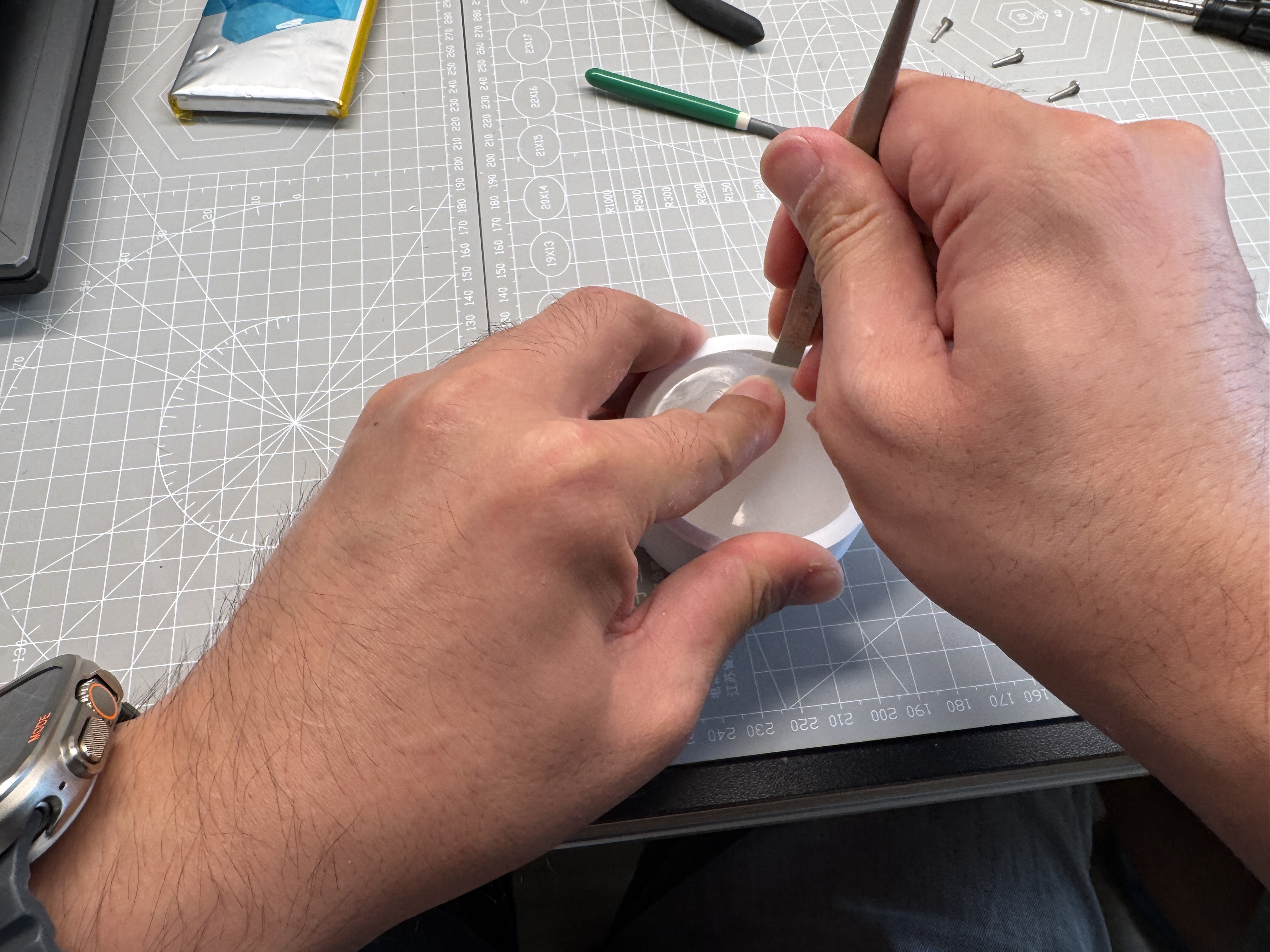 Using tweezers to open the silicone edge around the printed mold