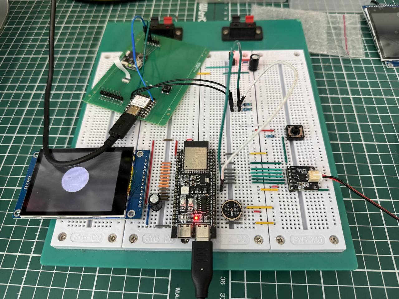 Overview photo of Forest Fairy v2 bench wiring: ESP32 boards, harvested mic and speaker, and interconnects
