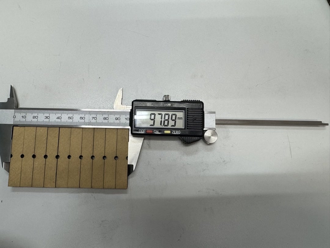 Measuring the kerf sample with calipers