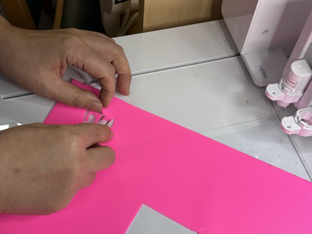 Weeding the vinyl with tweezers