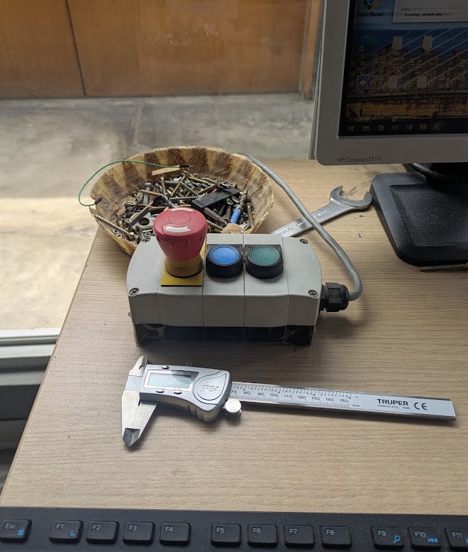 The e-stop; reset; and spindle control buttons