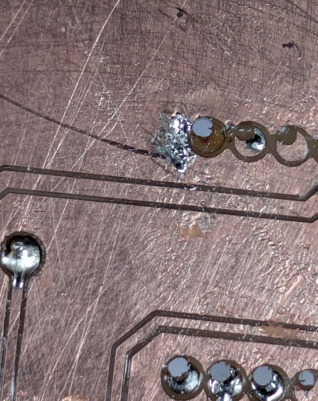 Exhibit B - This pad didn't even stand a chance. First of all - the Carvera biffed it (okay I biffed it) and the throughole isn't centered. Second of all - well... I accidentally soldered it to the ground plane which you'll read about why that's a problem...