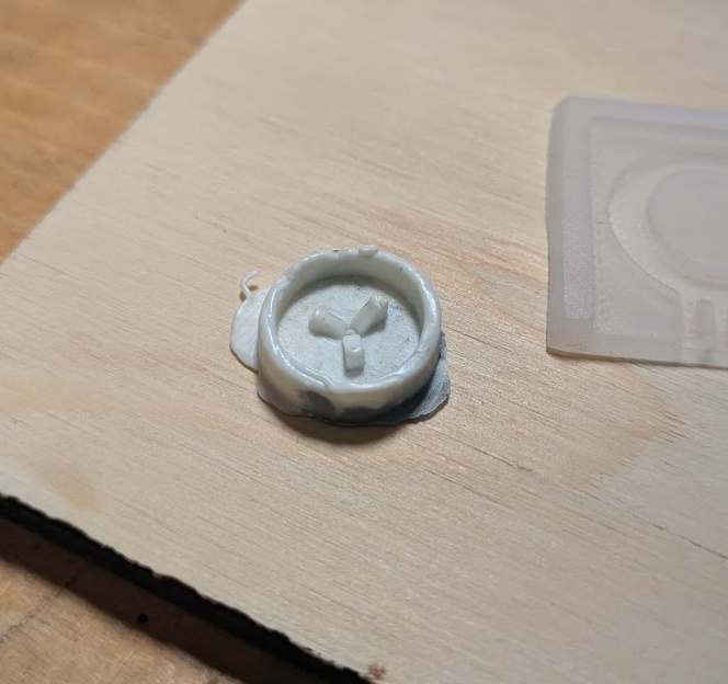 Okay maybe it's not completely obvious here because I'm using PLA scraps to cast this mold - you can see here the flange is incorrectly on the TOP (which is on the bottom in this image) - meaning the button would be inserted upside down! Really tricky to keep track of.