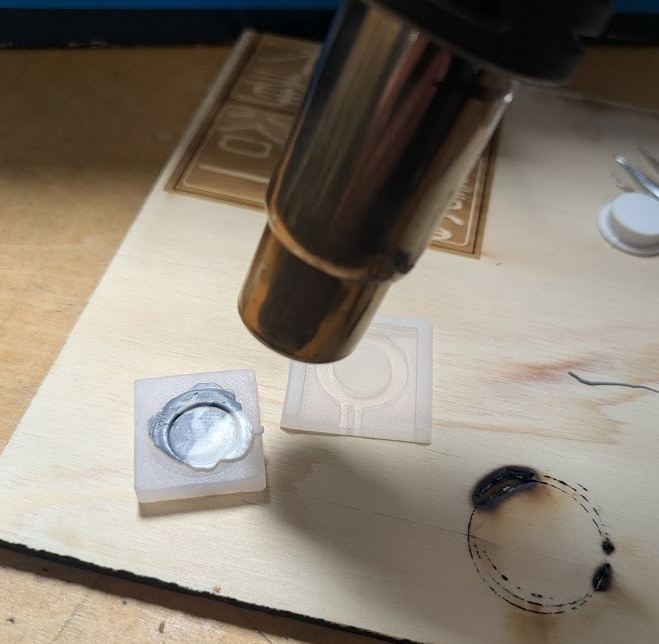 I tried the heat gun set at ~200 degrees Celsius at first - which worked fine - but took ages. I kept the airflow on medium-low - otherwise the PLA pieces would fly out of the mold.