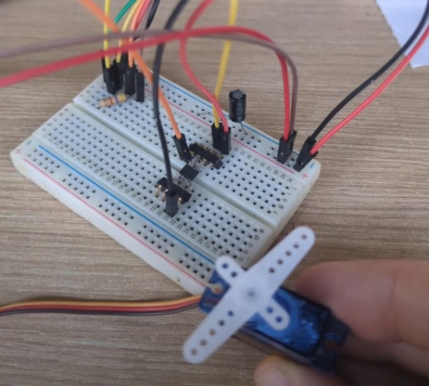 Critically, motors often produce spikes in voltage/current when they are moving, so it's a good idea to include a capacitor in your circuit like I've done here to ensure there is enough voltage at all times