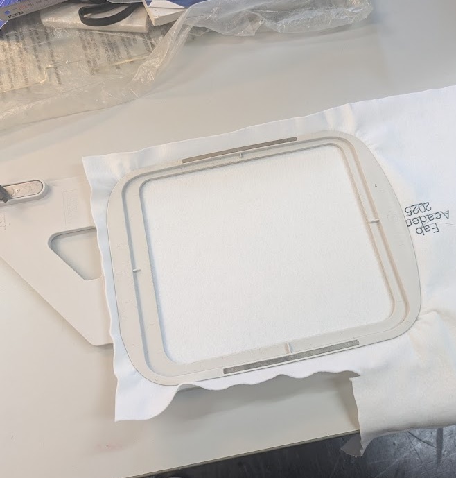 Frame your material in the provided plastic hoops. There are two sizes depending on your job.