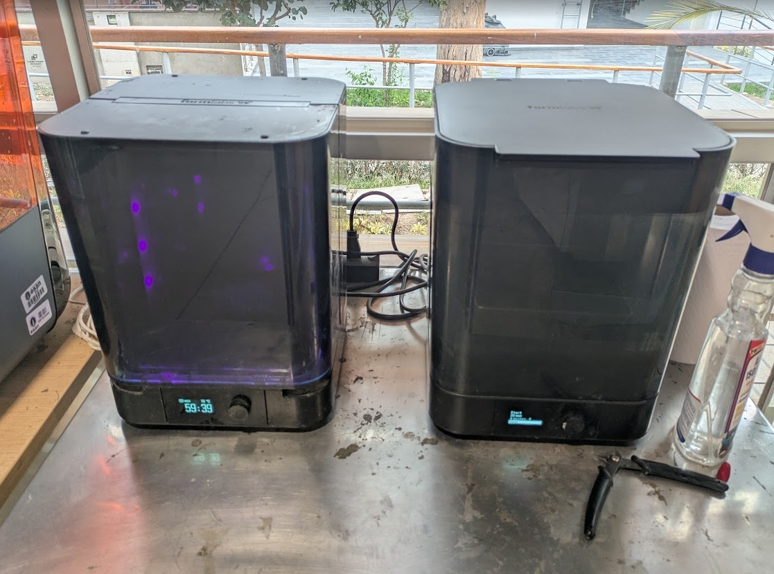 Unlike FDM - Resin needs to be washed off the print with isopropyl and then cured with a UV light and some heat before it's fully finished