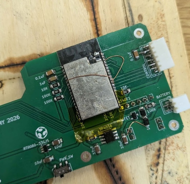 The slightly longer WROVER chip soldered onto the board with Kapton tape protecting the extra pins. I needed two bodge wires to hook up the shift register controls to the right place. 