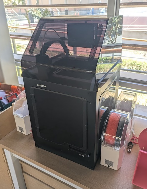 Zortrax M200. FDM. Build Volume: 200mm x 200mm x 200mm. Max speed: 100mm/s. Closed enclosure. Very old model but performs well with the company's own ABS.