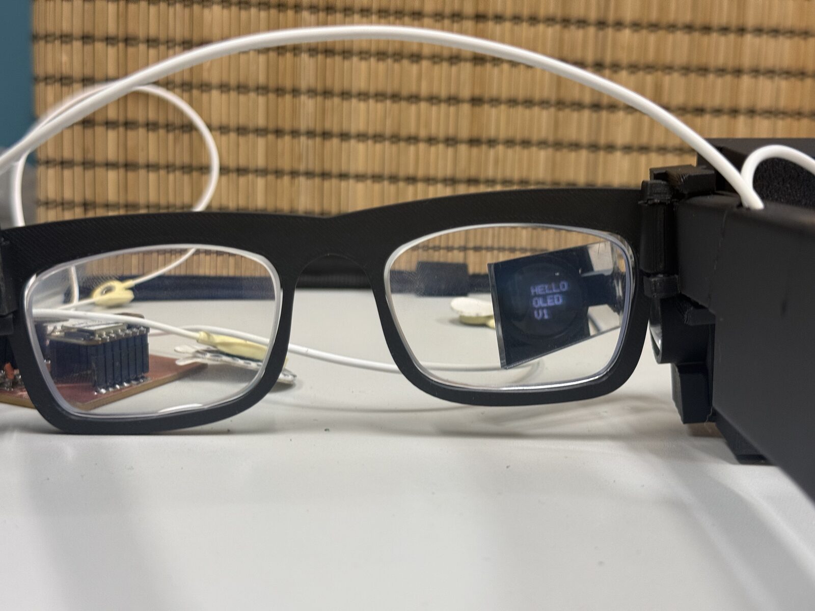 AR display mounted on the glasses with the OLED UI visible through the lens