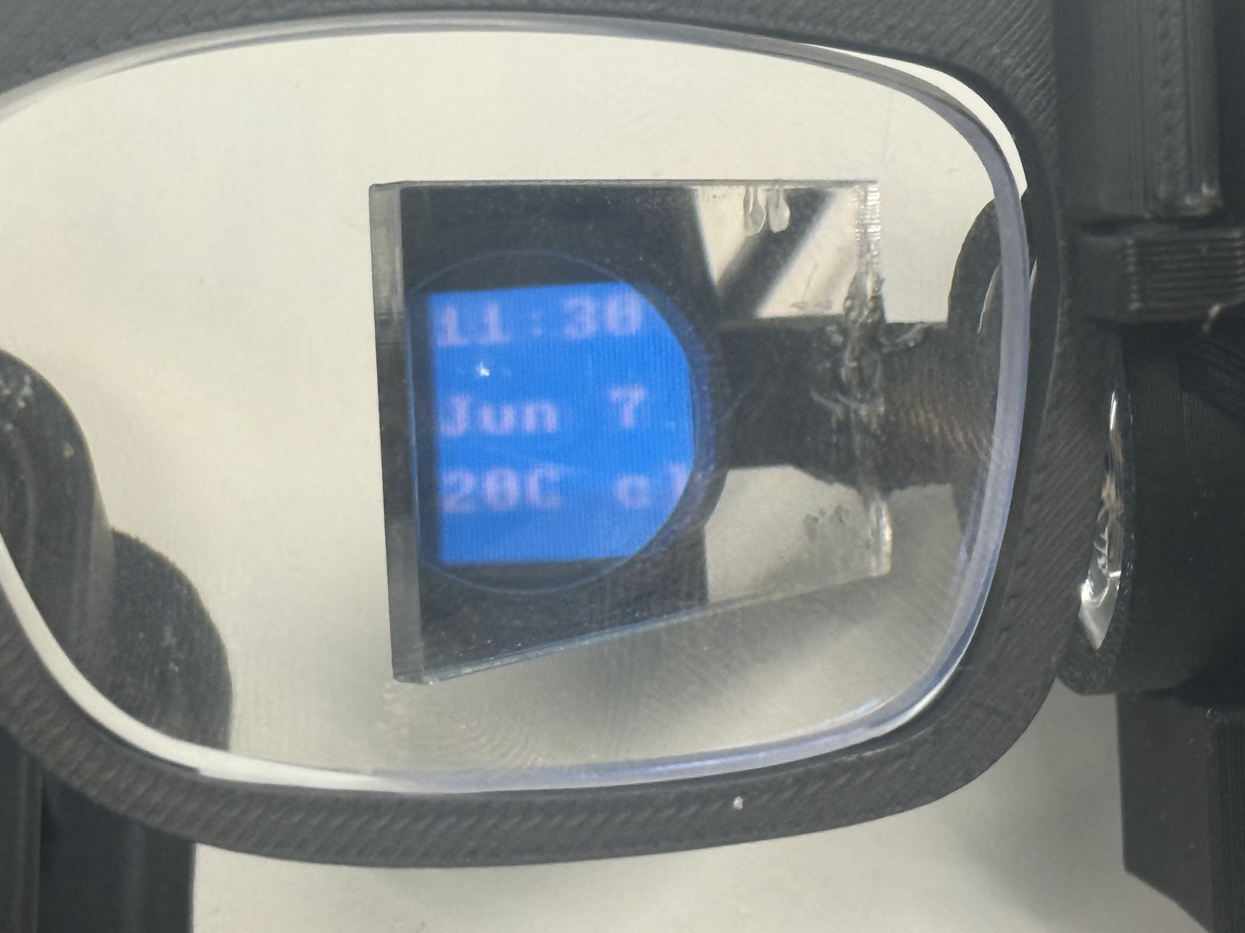 The time, date, and live weather page seen through the lens on the AR display