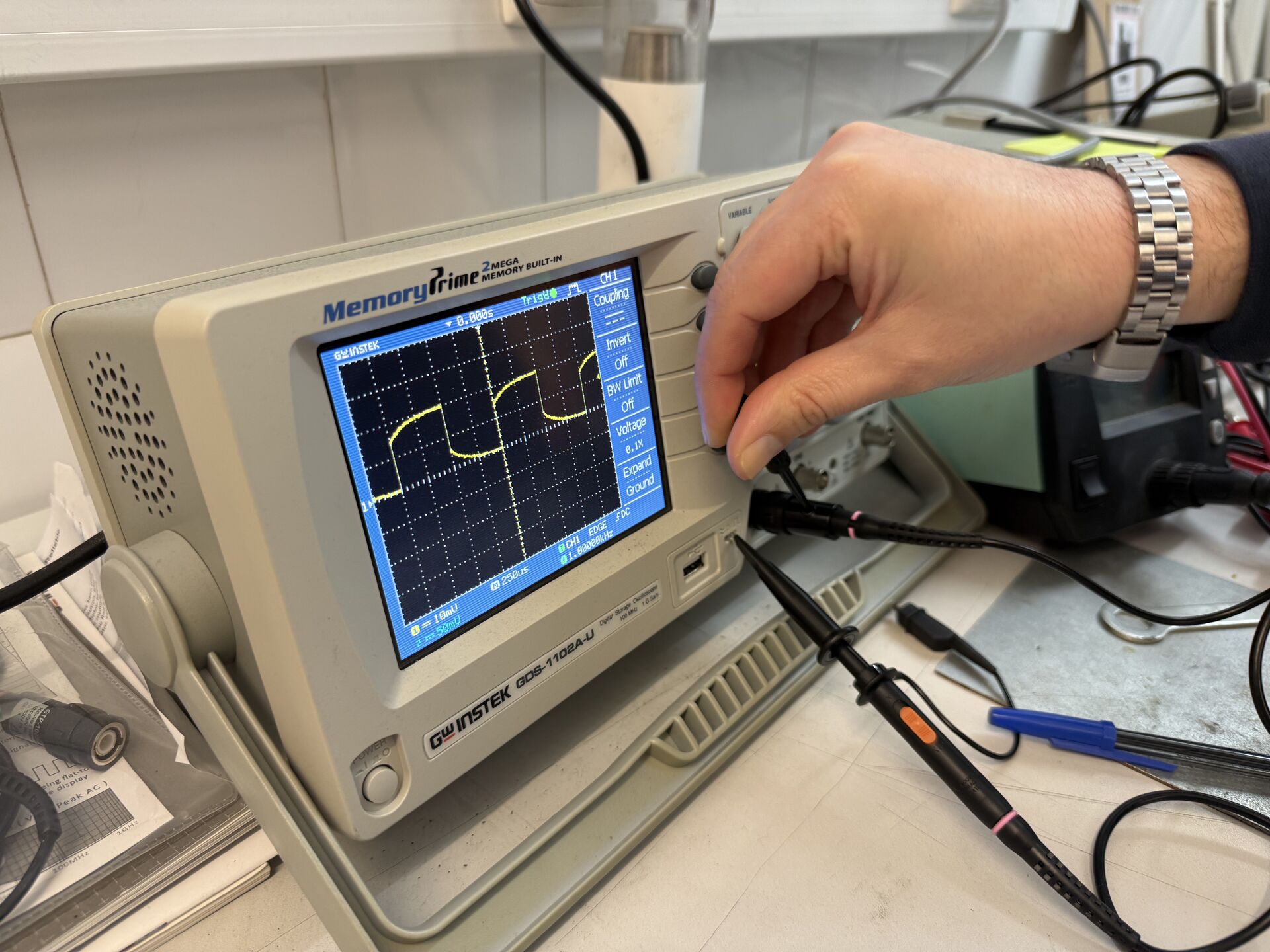 Close-up of oscilloscope screen — sine wave
