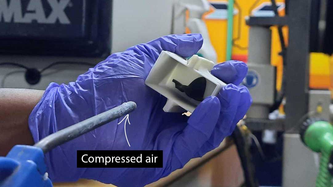 Compressed air is blown into the flask to clear any water droplets and it is left to dry.