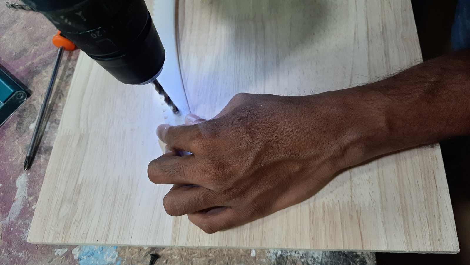 The acrylic gear mounting holes were countersunk using a drill bit slightly larger than the original hole diameter. This allowed the screw heads to sit flush with the gear surface. The operation was carried out with the assistance of the instructor.
