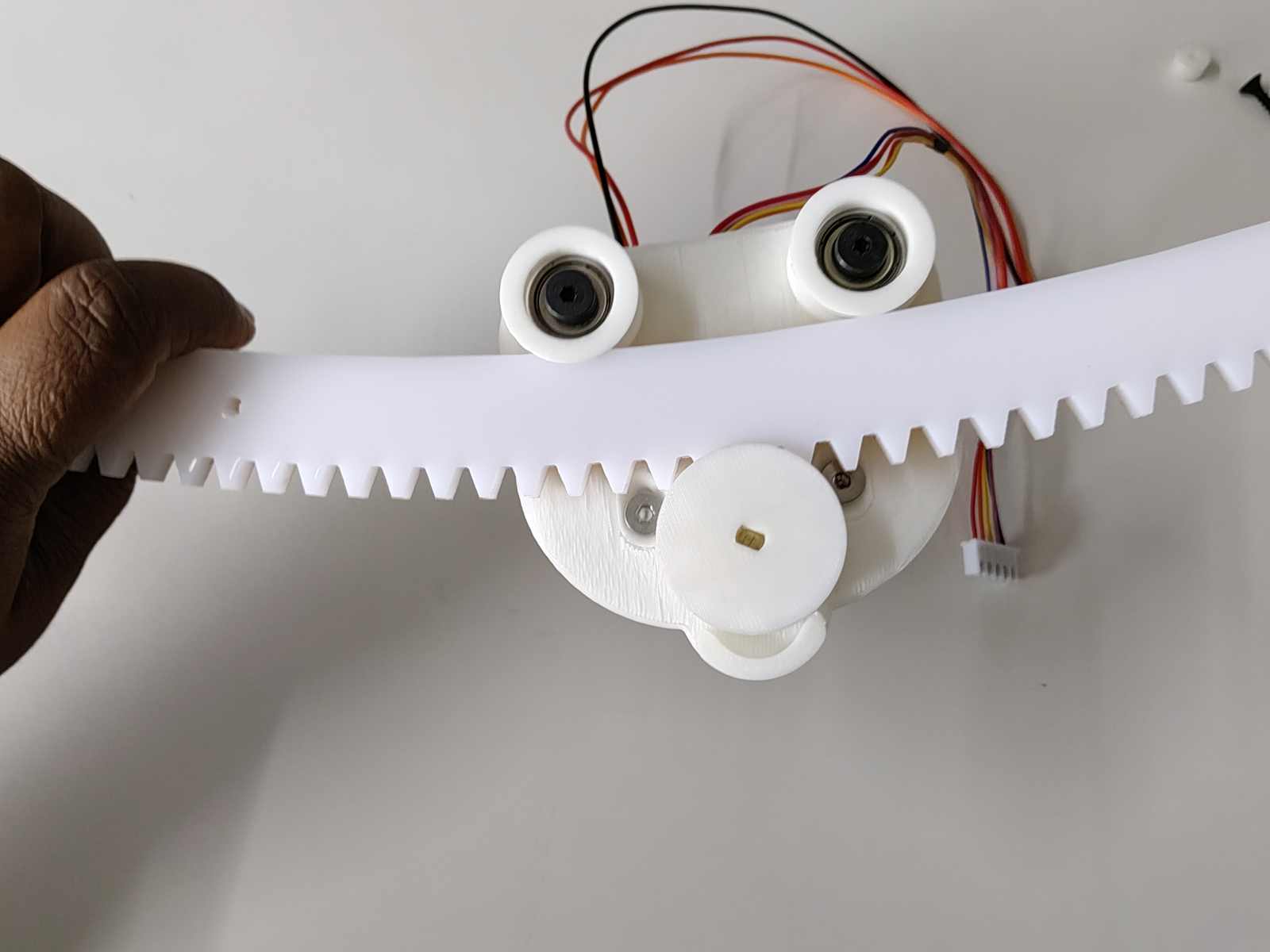 The slider mounted onto the gear assembly. The bearing holder slides along the lower guide, allowing controlled linear movement.
