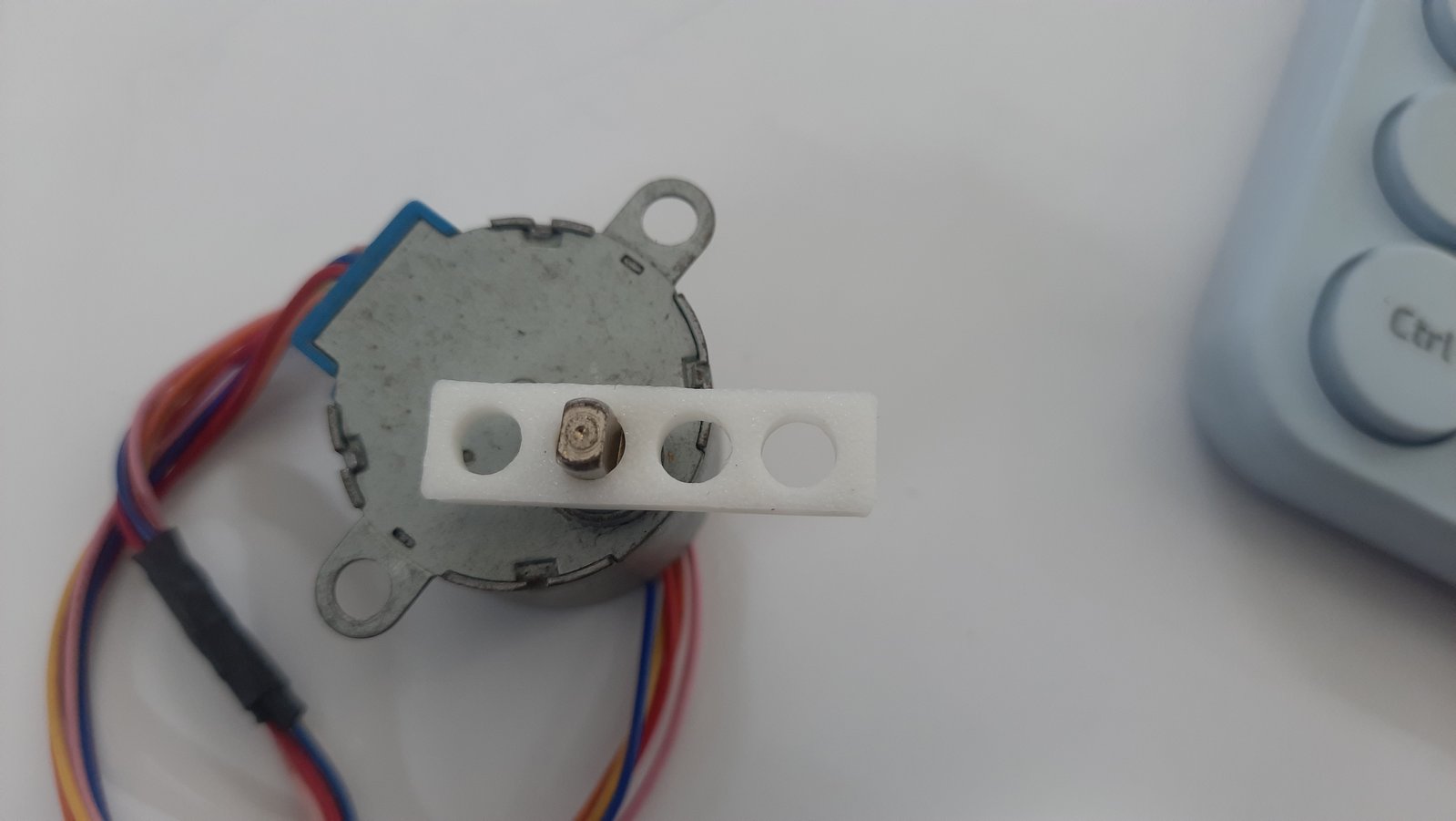 A small test jig designed to determine the correct press fit for the motor shaft before integrating it into the final assembly.