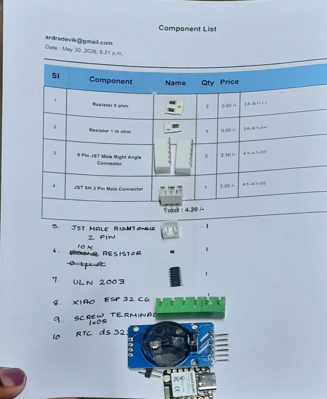 The components used on the main PCB are arranged before assembly. This includes the Xiao ESP32C6, RTC module, screw terminals, JST connectors, motor driver, and supporting components used on the board.