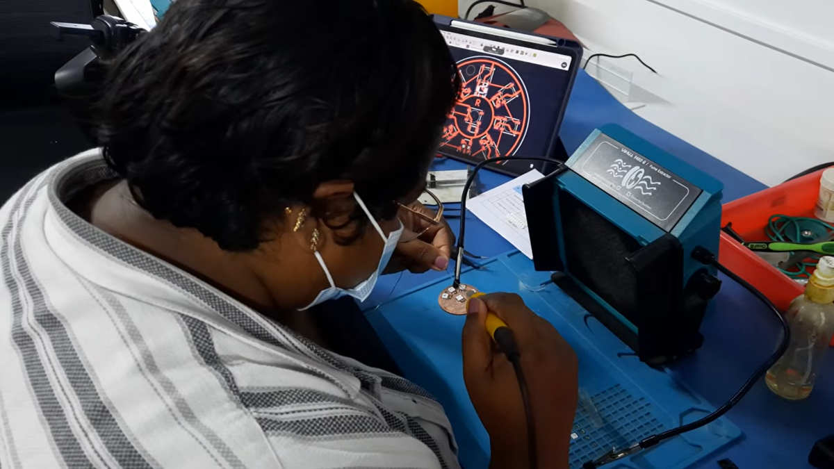 Soldering the NeoPixel ring PCB during the assembly process.
