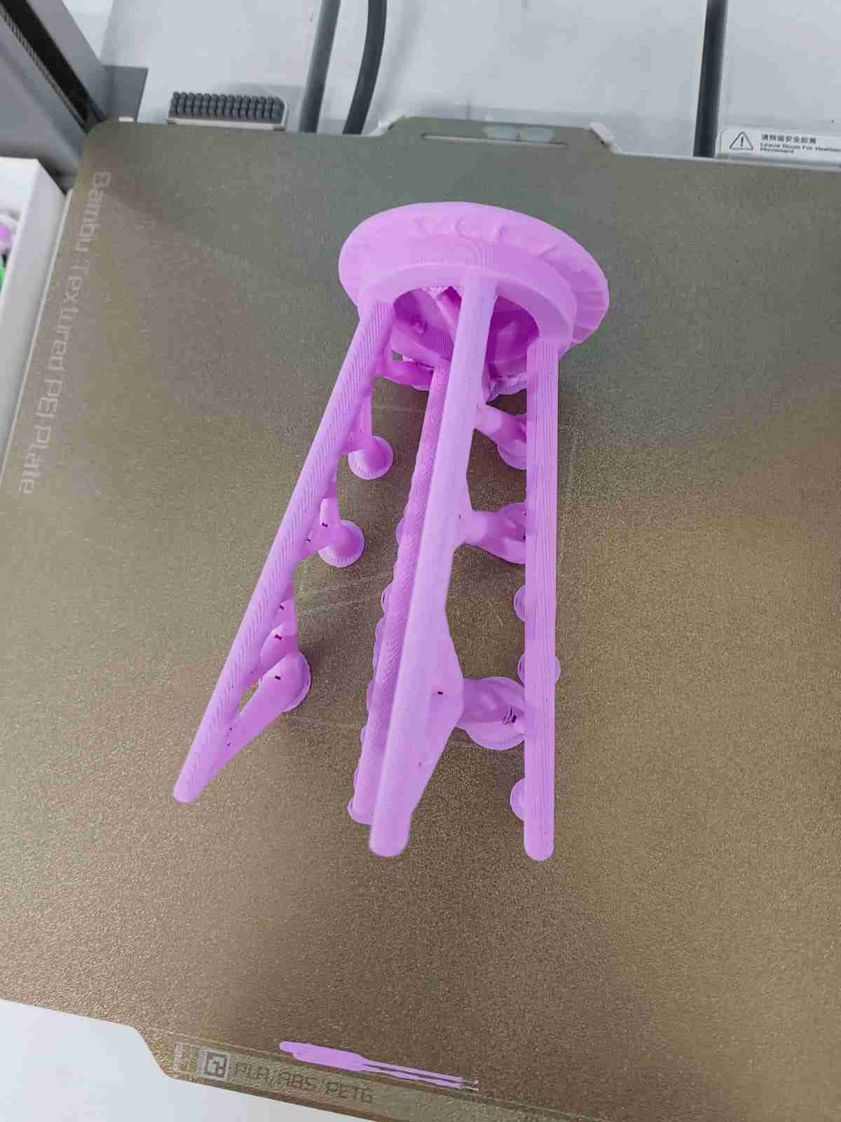 3D printed stool on the print bed with support structures