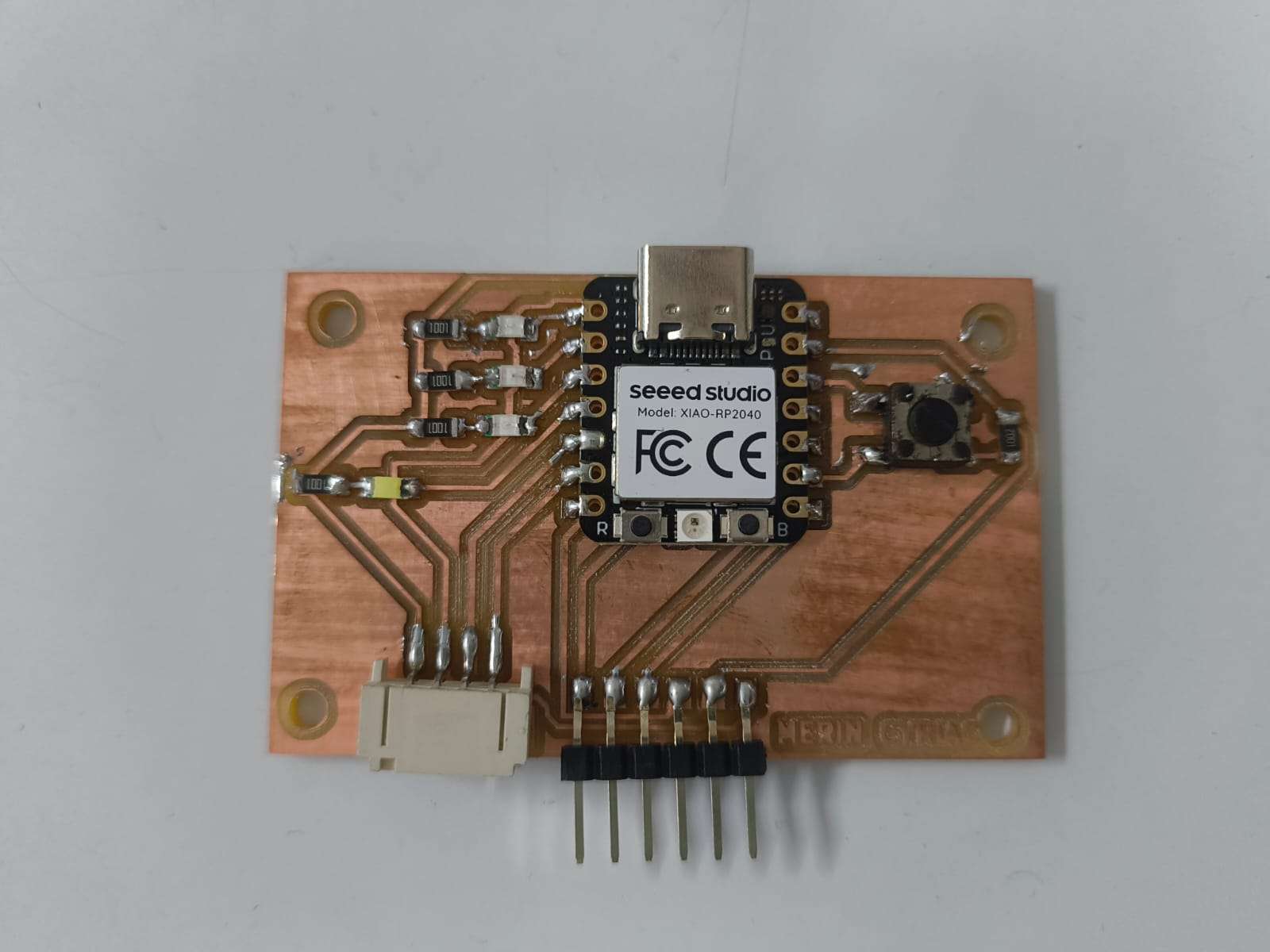 Fully populated PCB with XIAO RP2040, SMD resistors, LED, tactile button, and pin headers all soldered