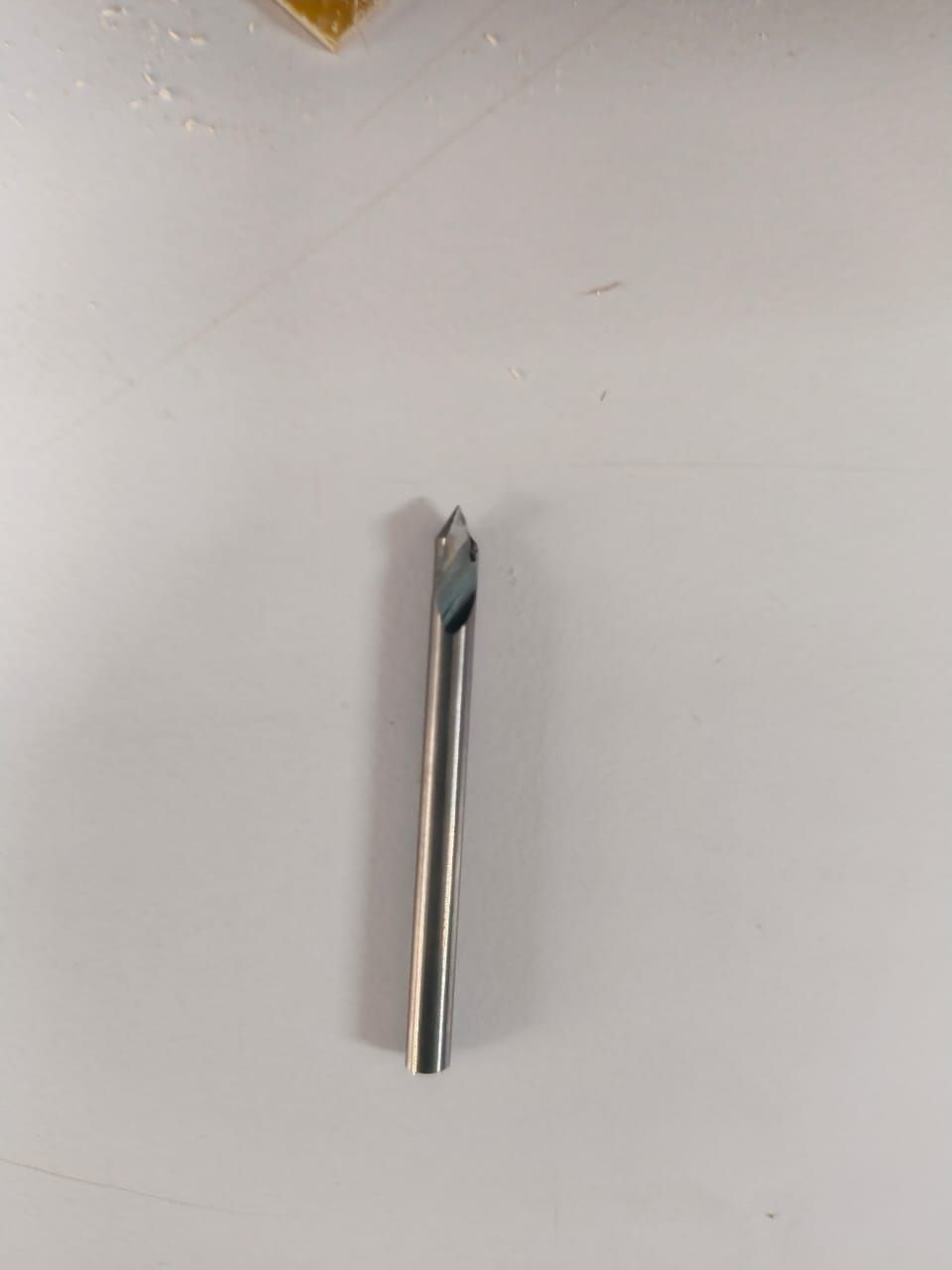 V-bit with a sharp pointed tip and cylindrical steel shank used for engraving PCB copper traces